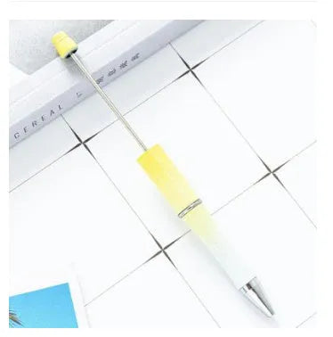 Creative ballpoint pen with multicoloured spinning plastic beads on a steel wire frame.