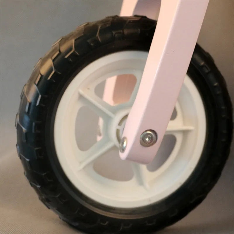 Pink wooden balance scooter for toddlers and children aged 1 to 6 years.