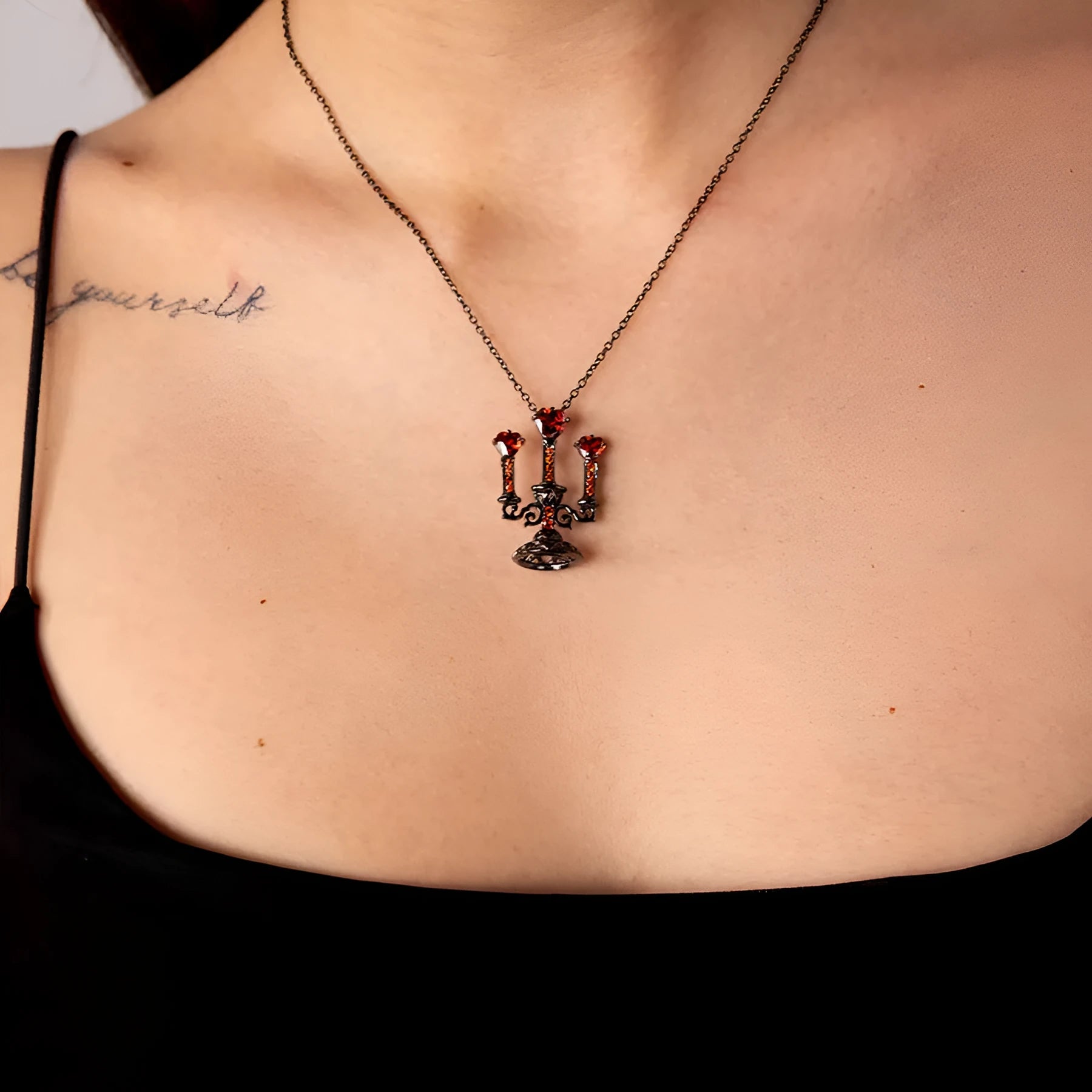 Women's vintage-style necklace with a detailed hollow candlestick pendant and cross chain in zinc alloy.
