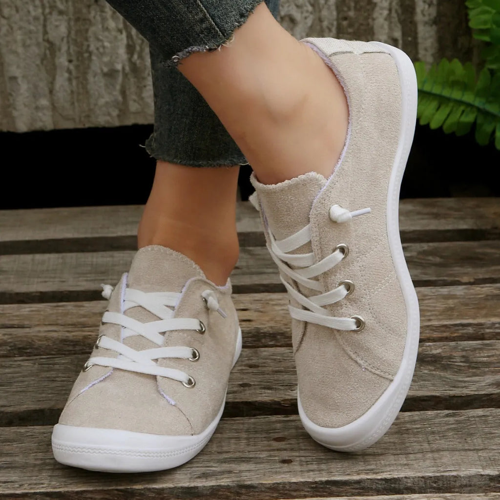Women's creamy white casual sneakers with fabric upper and rubber sole on multiple surfaces