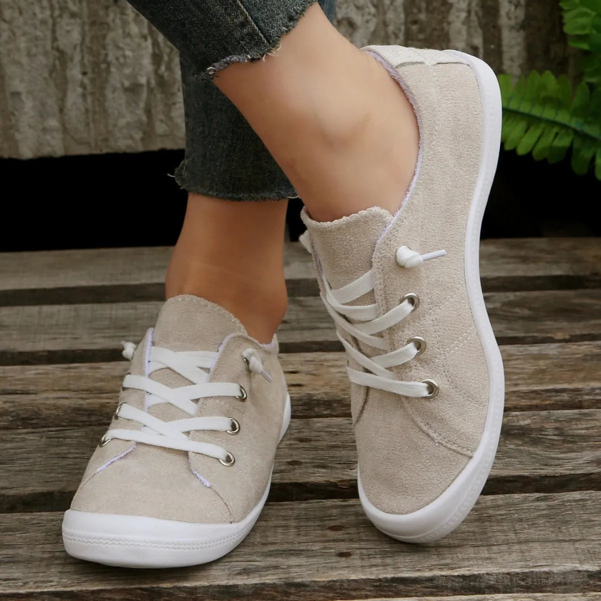 Women's creamy white casual sneakers with fabric upper and rubber sole on multiple surfaces