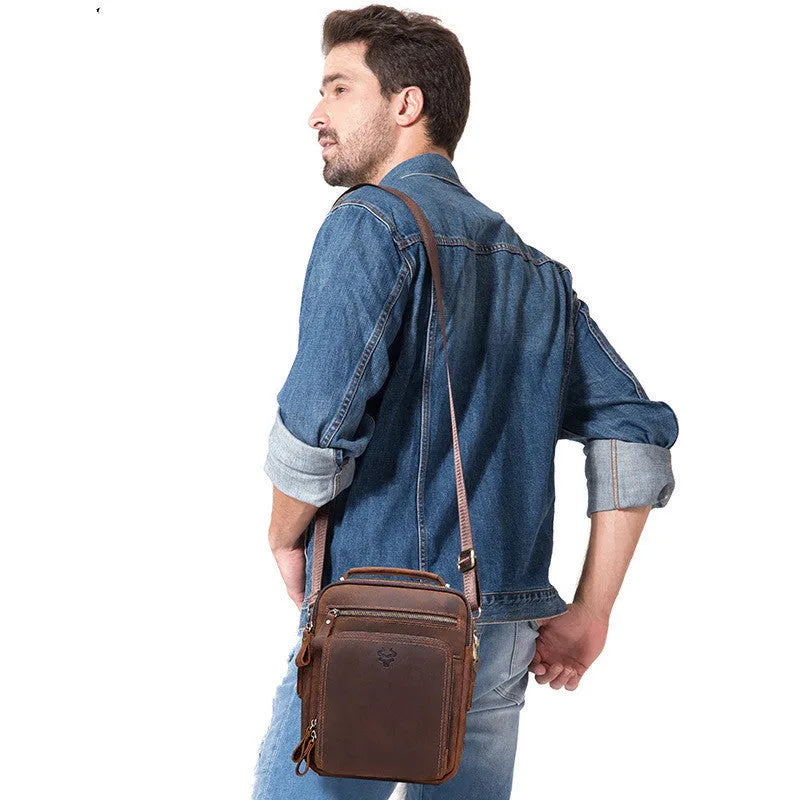 Men's brown leather crossbody bag with single-shoulder design showing sewing line details and business travel style