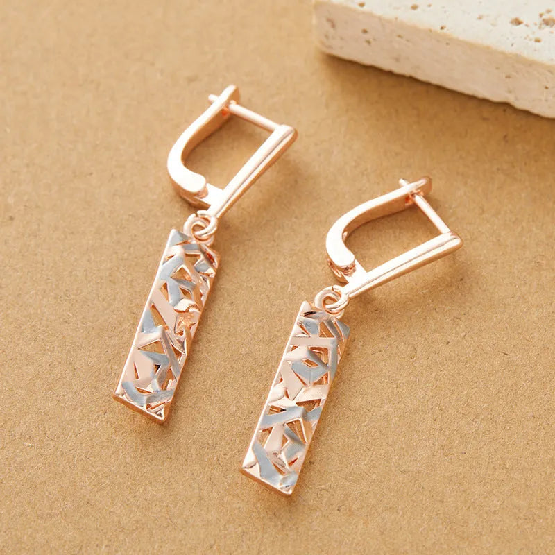 Rectangular two-tone hollow stud earrings with geometric openwork centre and electroplated finish