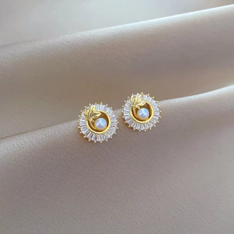 A titanium steel jewellery set with a square diamond and leaf design necklace and matching stud earrings.