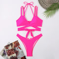 Women's solid colour strap bikini swimsuit in a brief style on a white background.