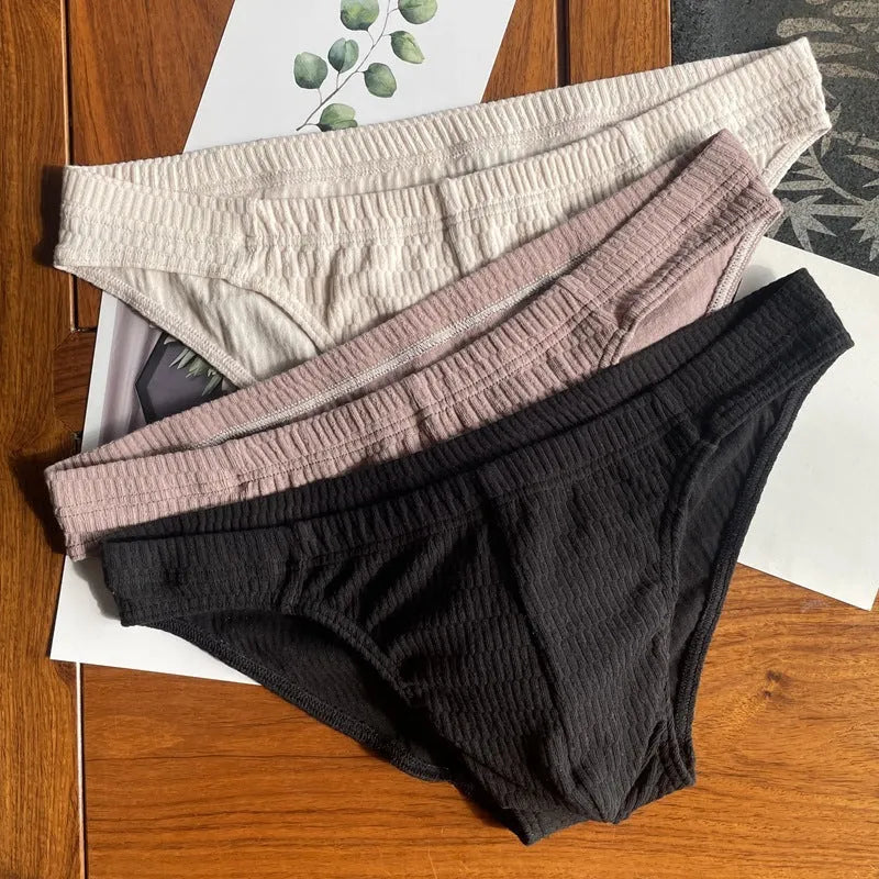 Men's solid colour cotton triangle underwear briefs with mid waistband, shown in apricot black colour.