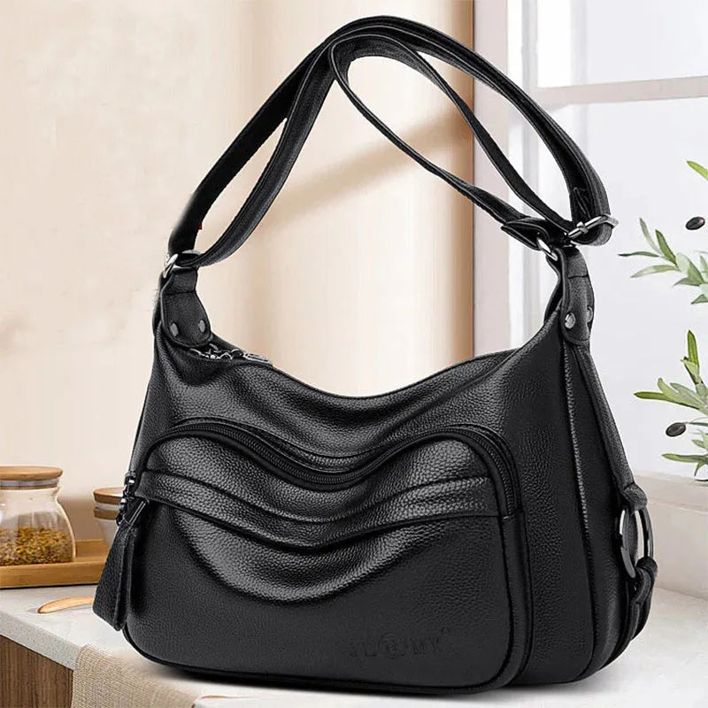 Blue horizontal square women's shoulder bag with soft PU construction and visible sewing thread detailing