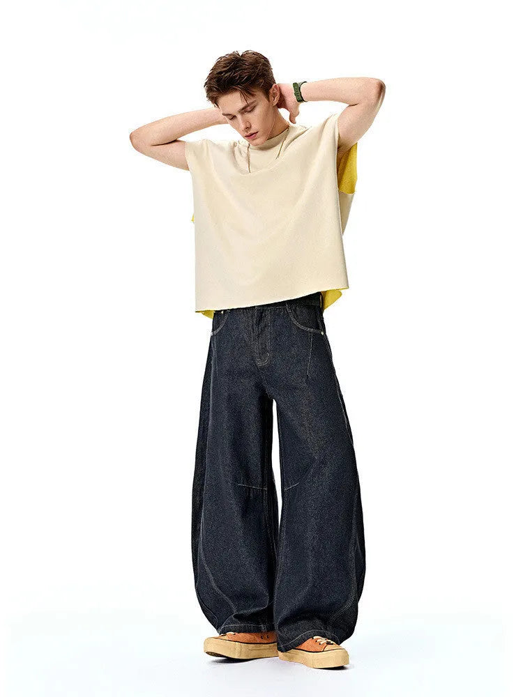 Men's original cow colour wide leg denim trousers with a mid-waist, laid flat.