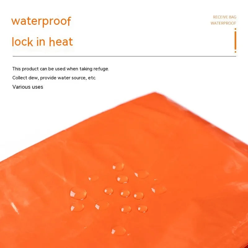 Orange portable disaster relief tent and sleeping bag kit set up outdoors.