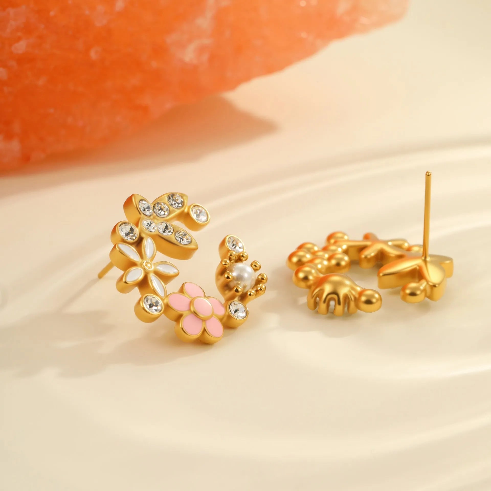 Gold flower stud earrings with petal design on stainless steel backing