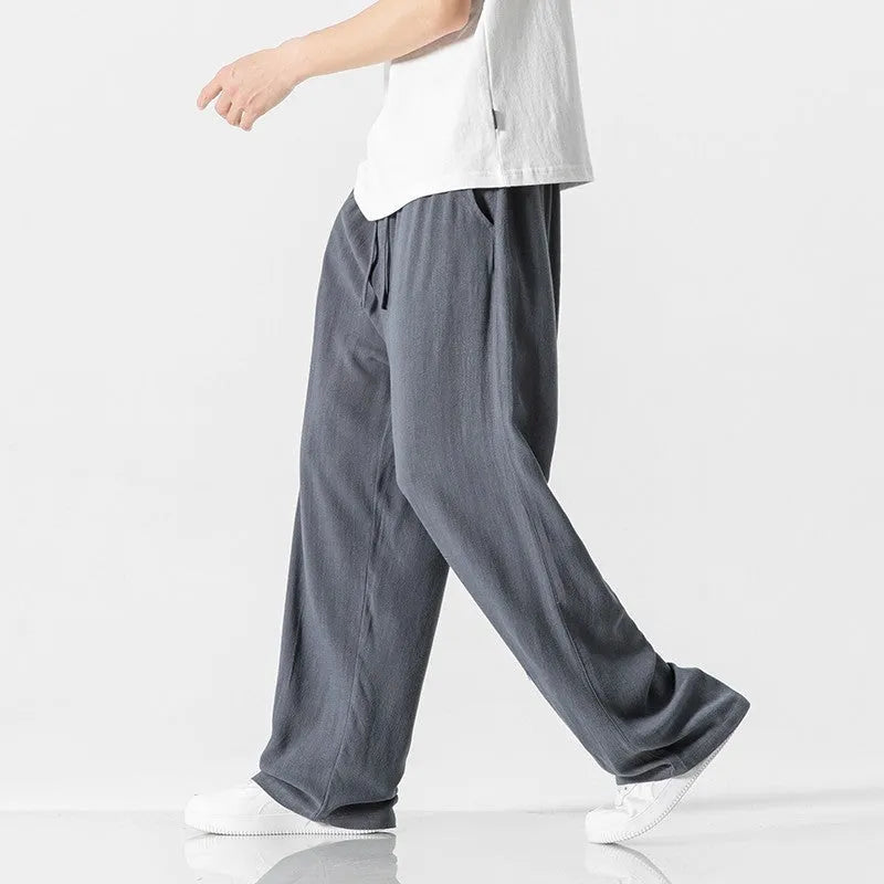 Men's beige linen casual trousers with a loose straight-leg fit and drawstring waist.
