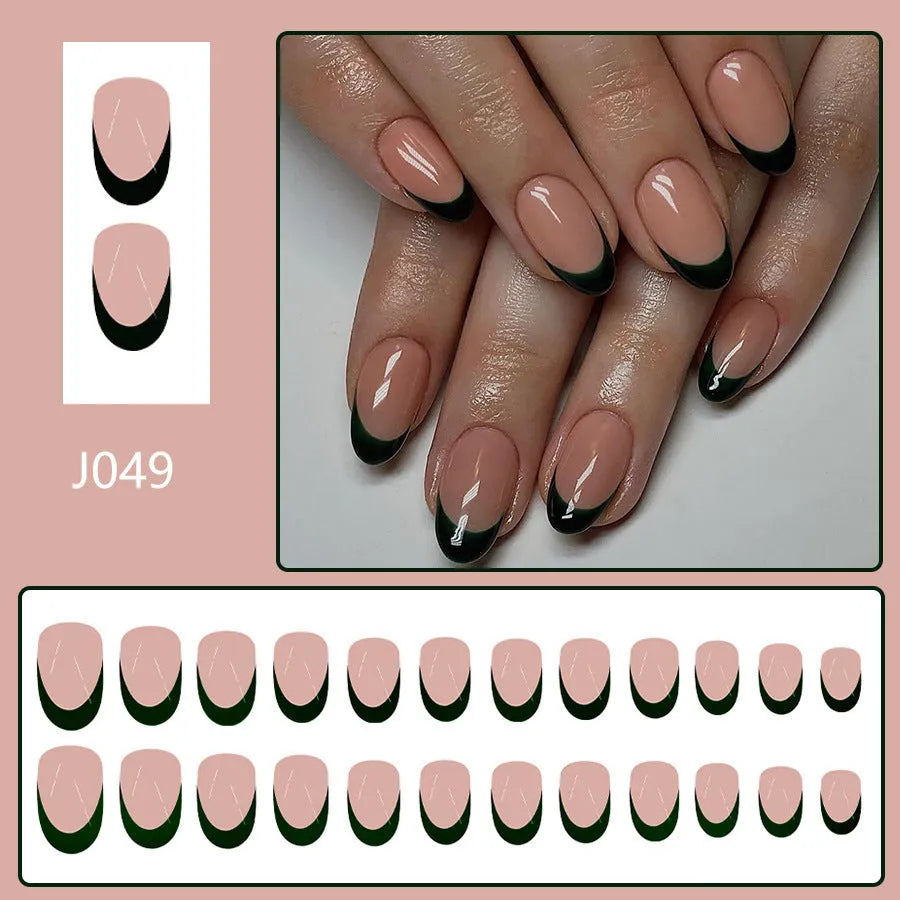 24 black French style acrylic false nails with short almond shape laid out on a surface.
