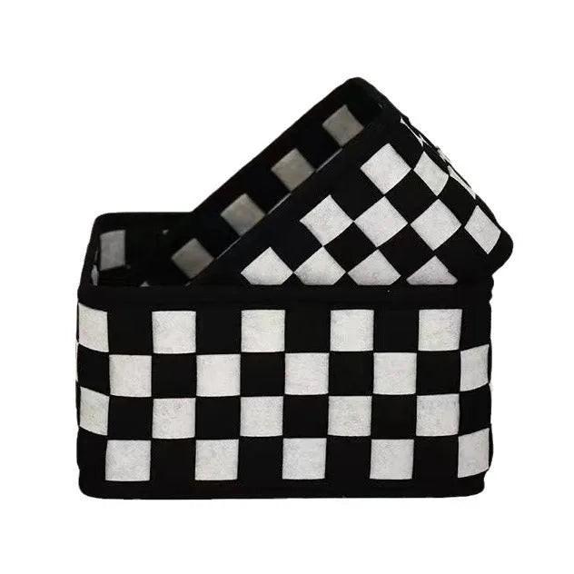 Checkerboard patterned grey and white felt folding storage box with woven design.