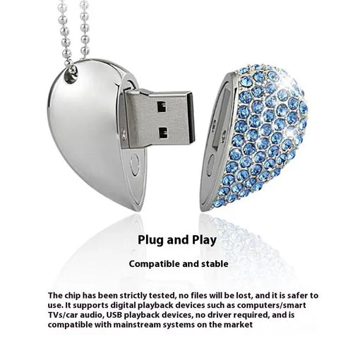 A heart-shaped silver USB flash drive with a brick pattern, shown next to a laptop.