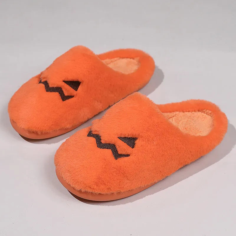 Orange Halloween pumpkin slippers with plush construction and non-slip soles in paired adult sizes
