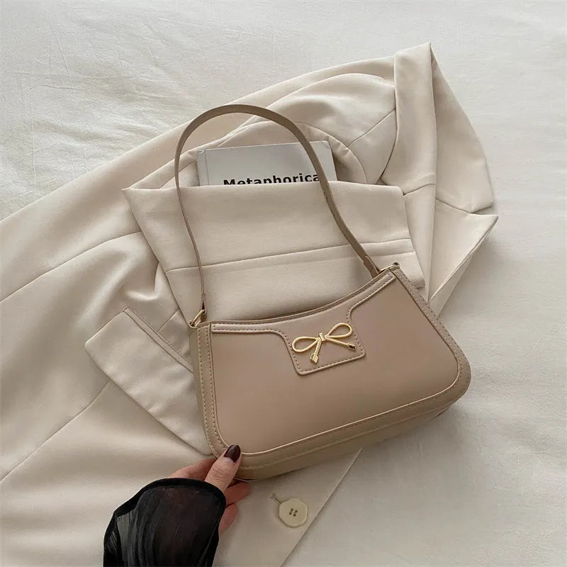 Western style PU leather shoulder bag with bow detail in horizontal square shape.