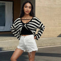 A striped long-sleeved pullover sweater with a cropped front and back design, shown in a selected colour.