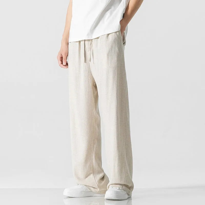 Men's beige linen casual trousers with a loose straight-leg fit and drawstring waist.