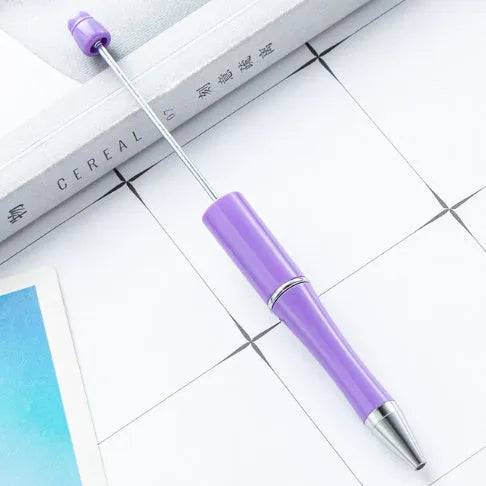 Creative ballpoint pen with multicoloured spinning plastic beads on a steel wire frame.