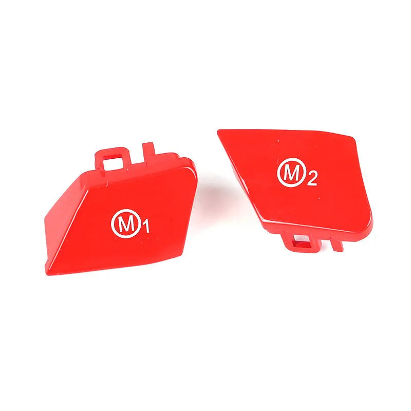 Pair of red and blue BMW steering wheel M1 and M2 mode replacement buttons on a white background.