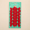Red and gold 5 cm polyester Christmas decoration bow on a green tree branch.