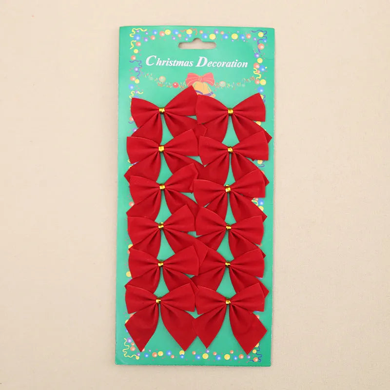 Red and gold 5 cm polyester Christmas decoration bow on a green tree branch.