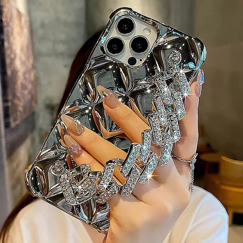 Gold diamond bracelet attached by chain to a TPU phone case for iPhone.