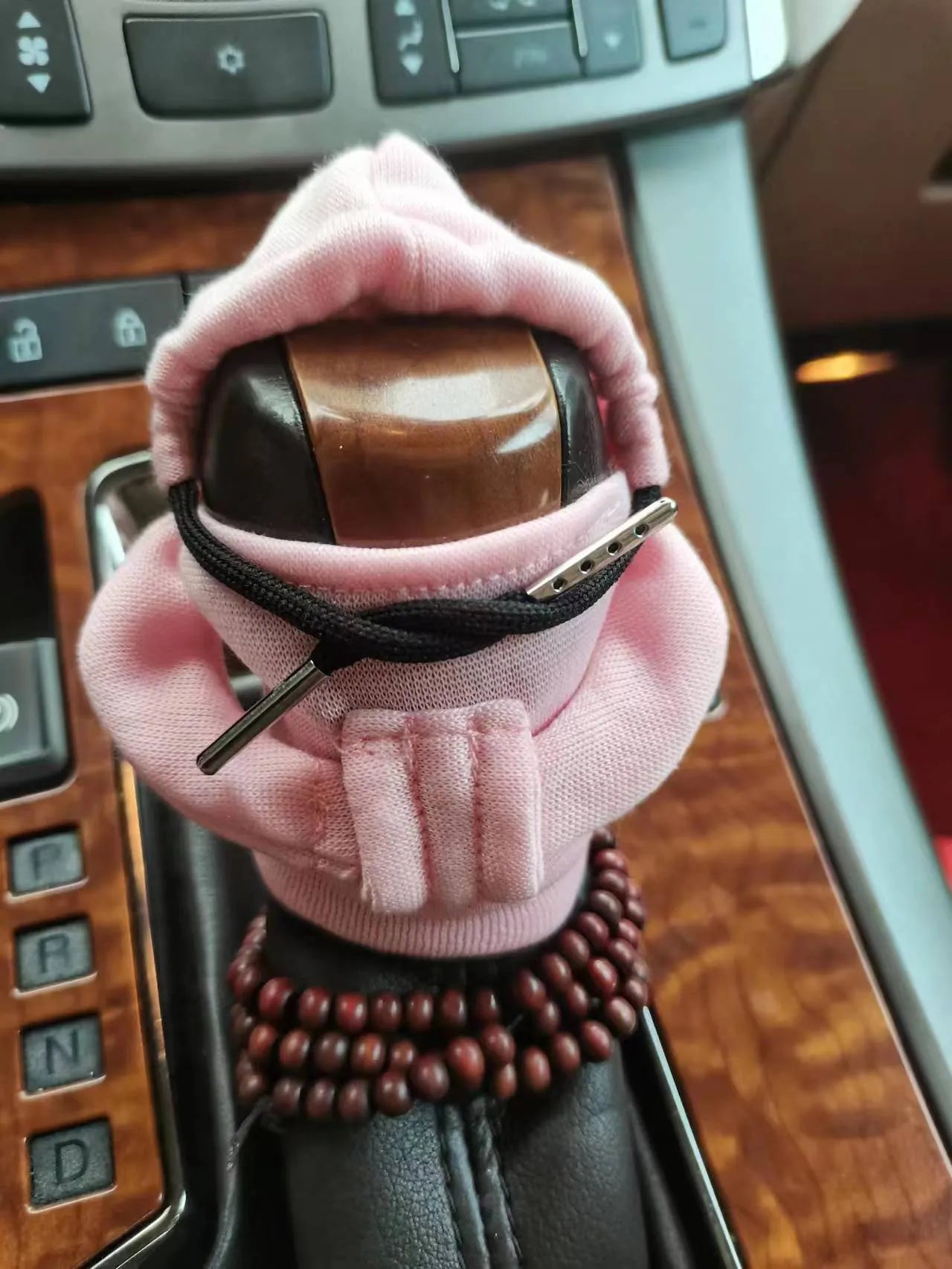 Soft Dutch velvet car gear handle cover in multiple colours on a gear stick.
