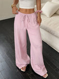 Women's black wide-leg trousers with lace-up waist trimming detail on hanger