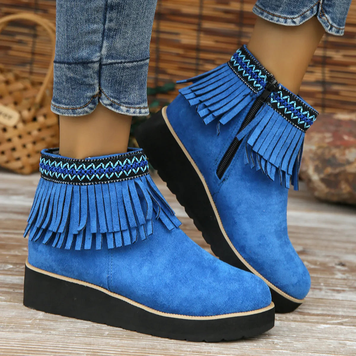 Women's dark brown suede wedge bootie with thick sole, side zipper, and tassel detail.