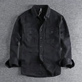 Man wearing a loose fit, long sleeve cardigan-style shirt overall in khaki polyester fabric.