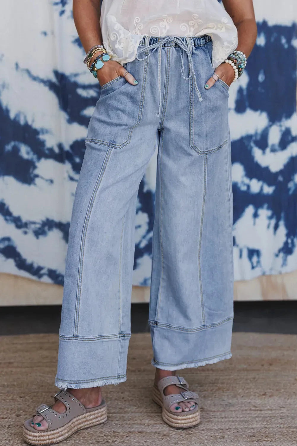 Beau Blue women's wide leg denim pants with drawstring waist and raw hem detailing.