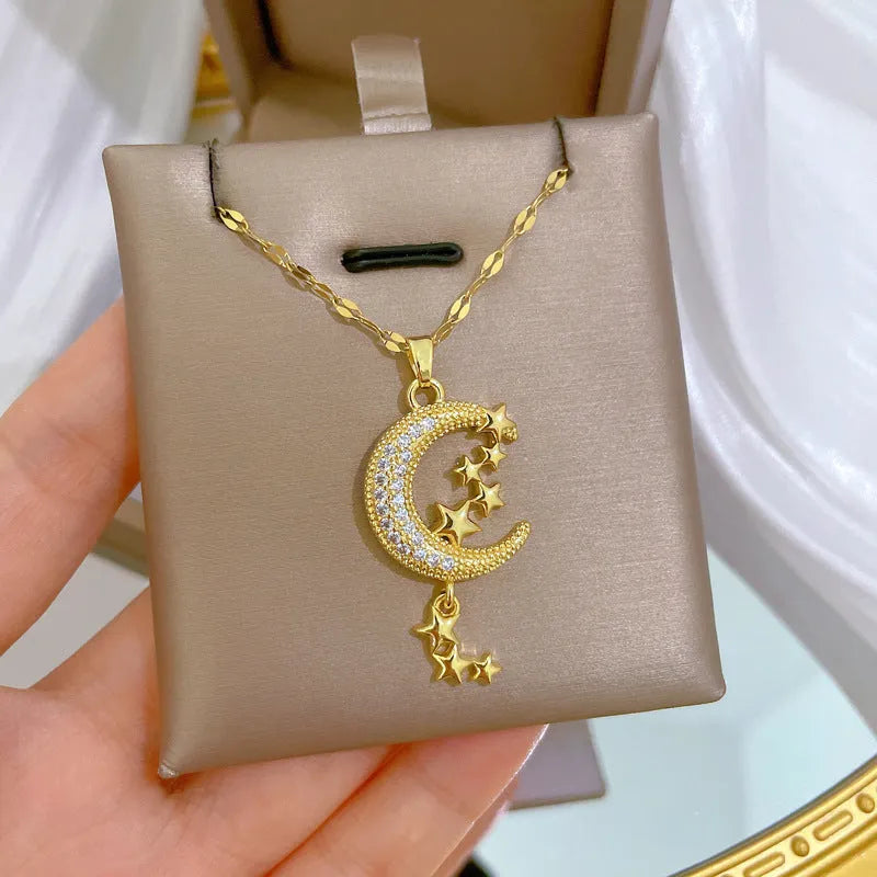 Moon-themed necklace with geometric copper pendant featuring tassel and diamond details on stainless steel chain