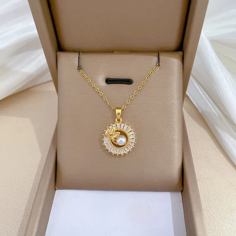 A titanium steel jewellery set with a square diamond and leaf design necklace and matching stud earrings.