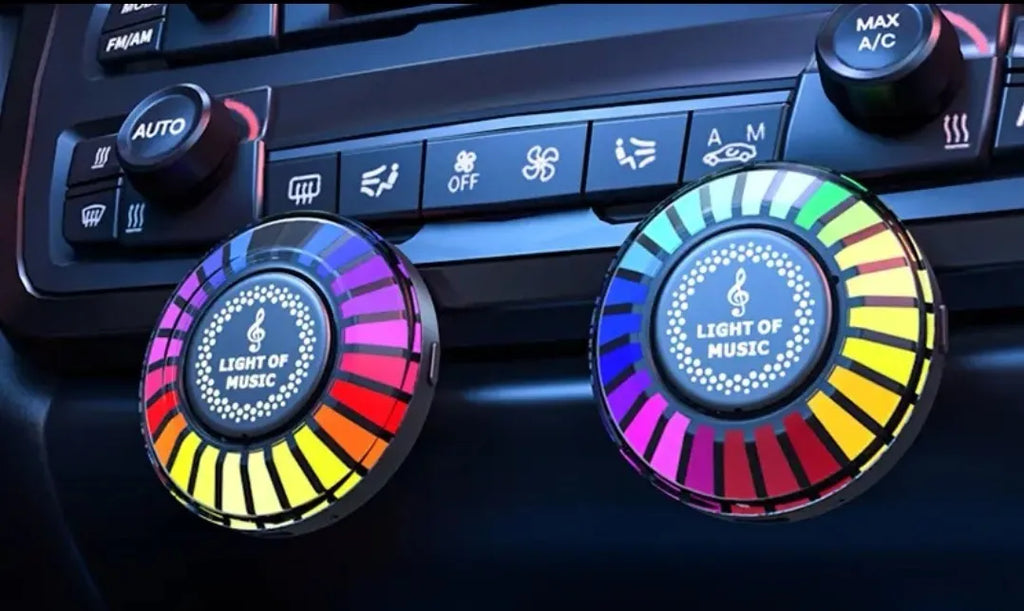 3D RGB car atmosphere light with aromatherapy mounted on a vehicle air outlet vent showing colorful lighting effects.