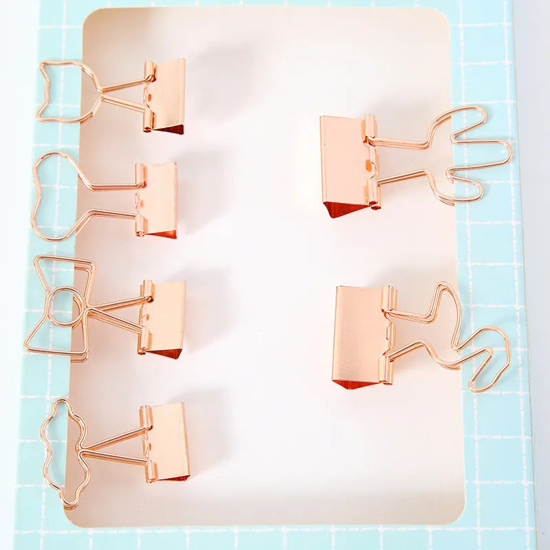 Gold-plated long tail metal paper clip showing decorative flamingo, love, clouds, cat, cactus, and bow design options.