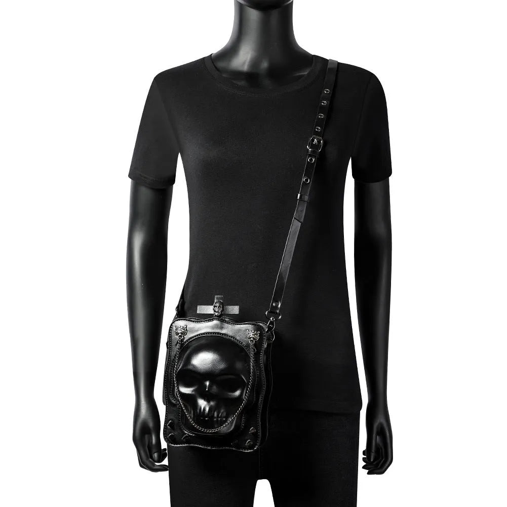Black gothic skull crossbody bag with square shape, stitching and metal rivet detailing