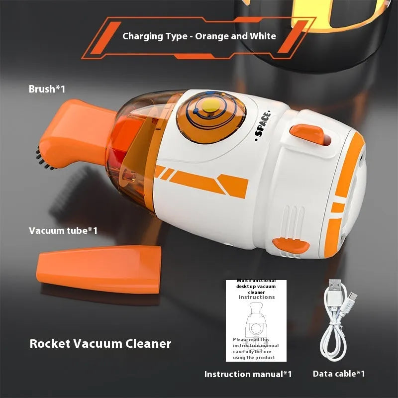 USB charging handheld desktop vacuum cleaner in blue rocket design on computer keyboard