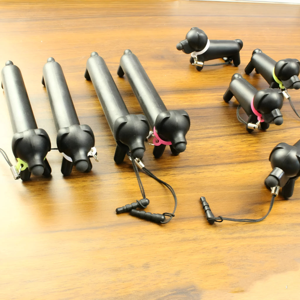 Black dog-shaped touch screen stylus pen showing adjustable length design and phone holder functionality