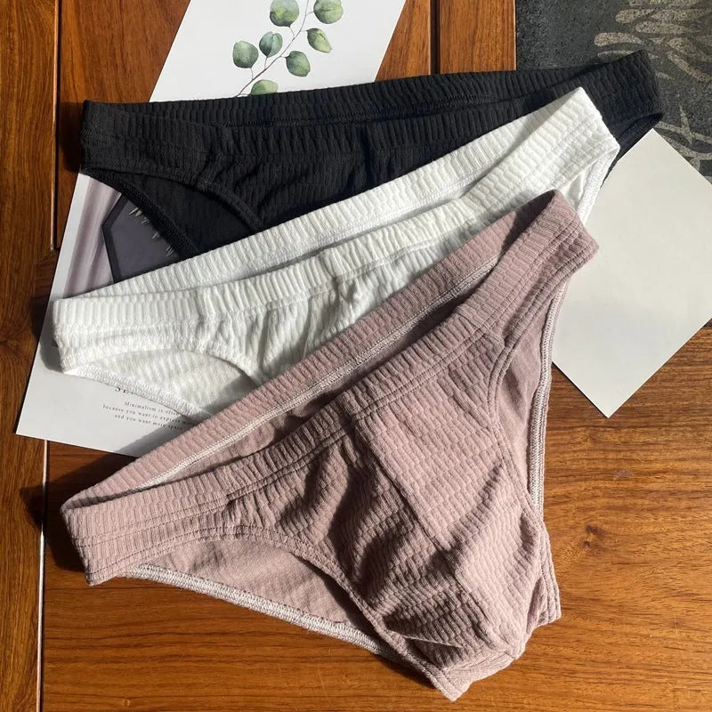 Men's solid colour cotton triangle underwear briefs with mid waistband, shown in apricot black colour.