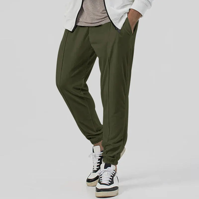 Men's grey casual tapered sweatpants with an elasticated waistband laid flat.