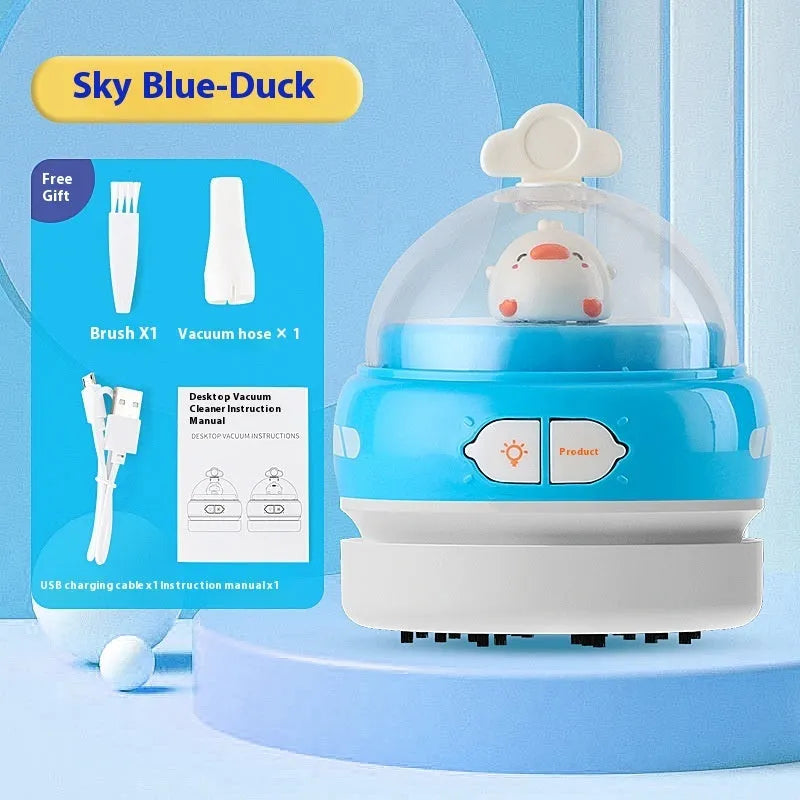 USB charging handheld desktop vacuum cleaner in blue rocket design on computer keyboard