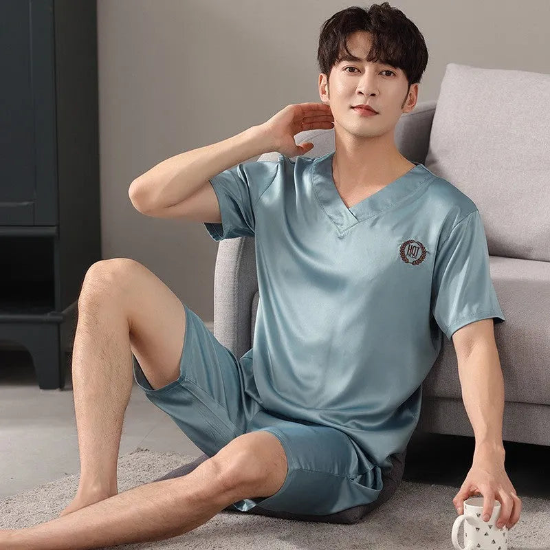 Man's light blue ice silk pyjama set with short sleeves and loose shorts laid flat.