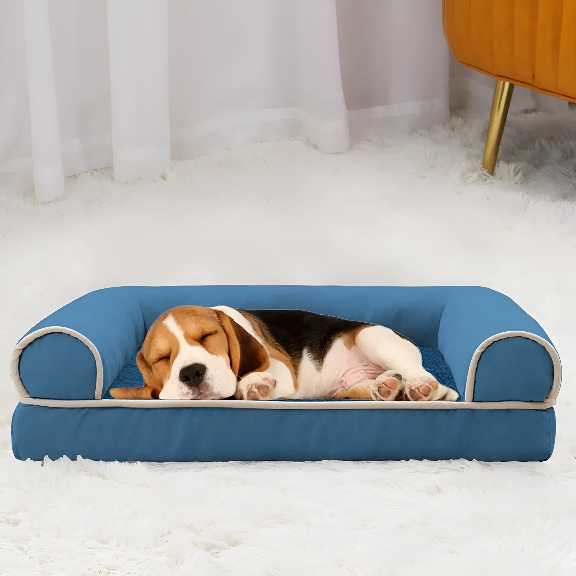 A square, cloth-covered sponge dog bed shown in blue, with a dog resting on it.