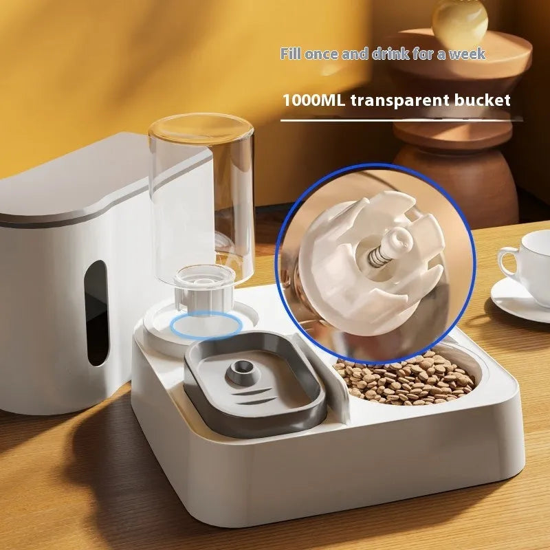 Grey automatic cat feeder and water dispenser station with integrated double bowls on a wooden floor.