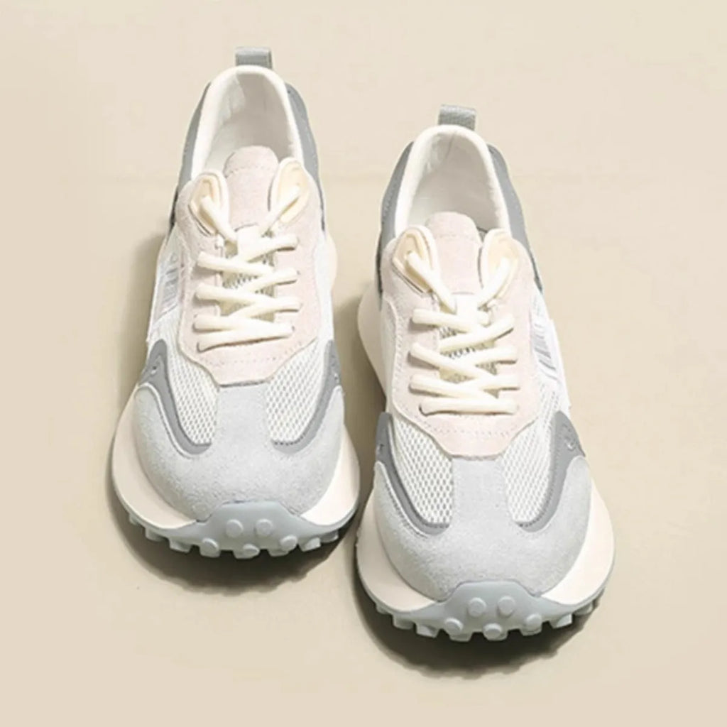 Women's grey retro sneaker with round toe and rubber sole showing mesh lining interior