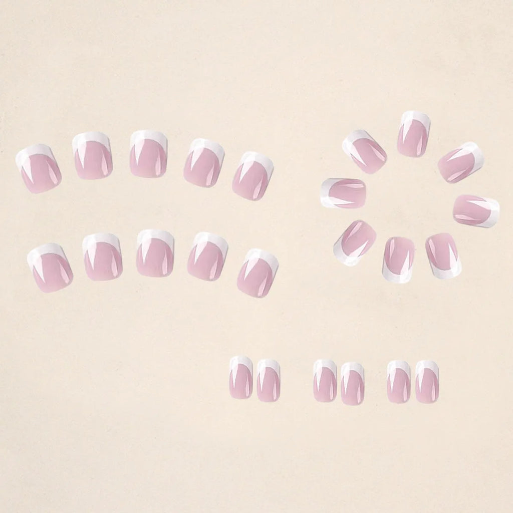 24 white false nail tips with a plaid pattern, laid out on a surface