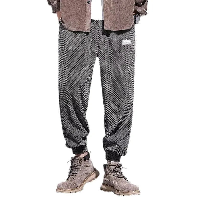 Men's grey ankle-tied casual sweatpants with a light straight leg on a neutral background.