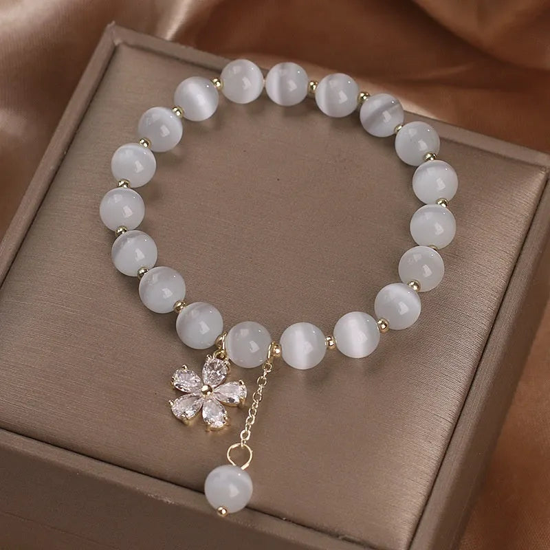 White cat's eye stone women's bracelet with flower tassels and safety buckle
