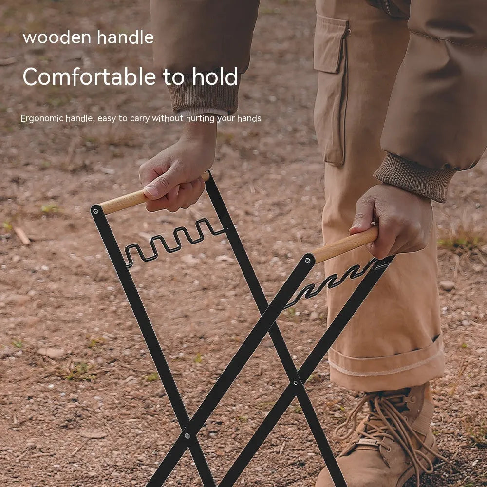 Black iron folding storage rack with a wooden handle for hanging outdoor waste bags.